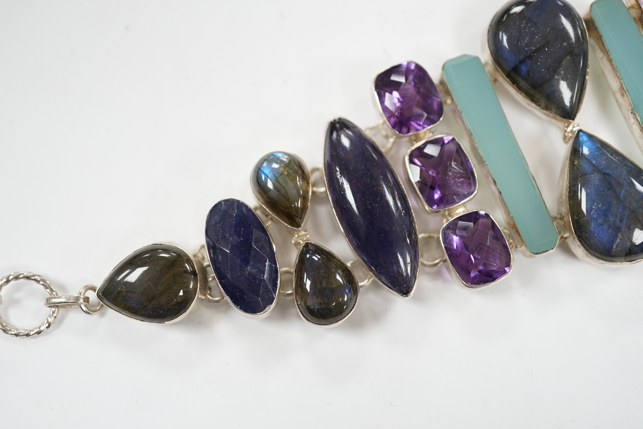 A white metal and multi gem set bracelet, including dyed agate, amethyst and labradorite, 21cm.